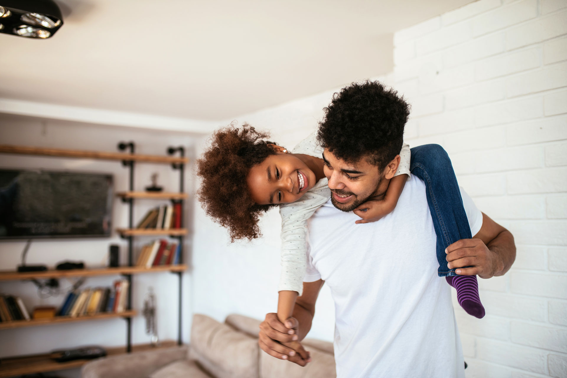 Young girl and her father laughing