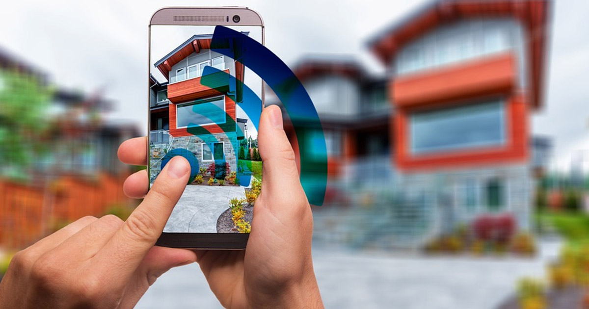 A person remotely monitoring their house using smart technology